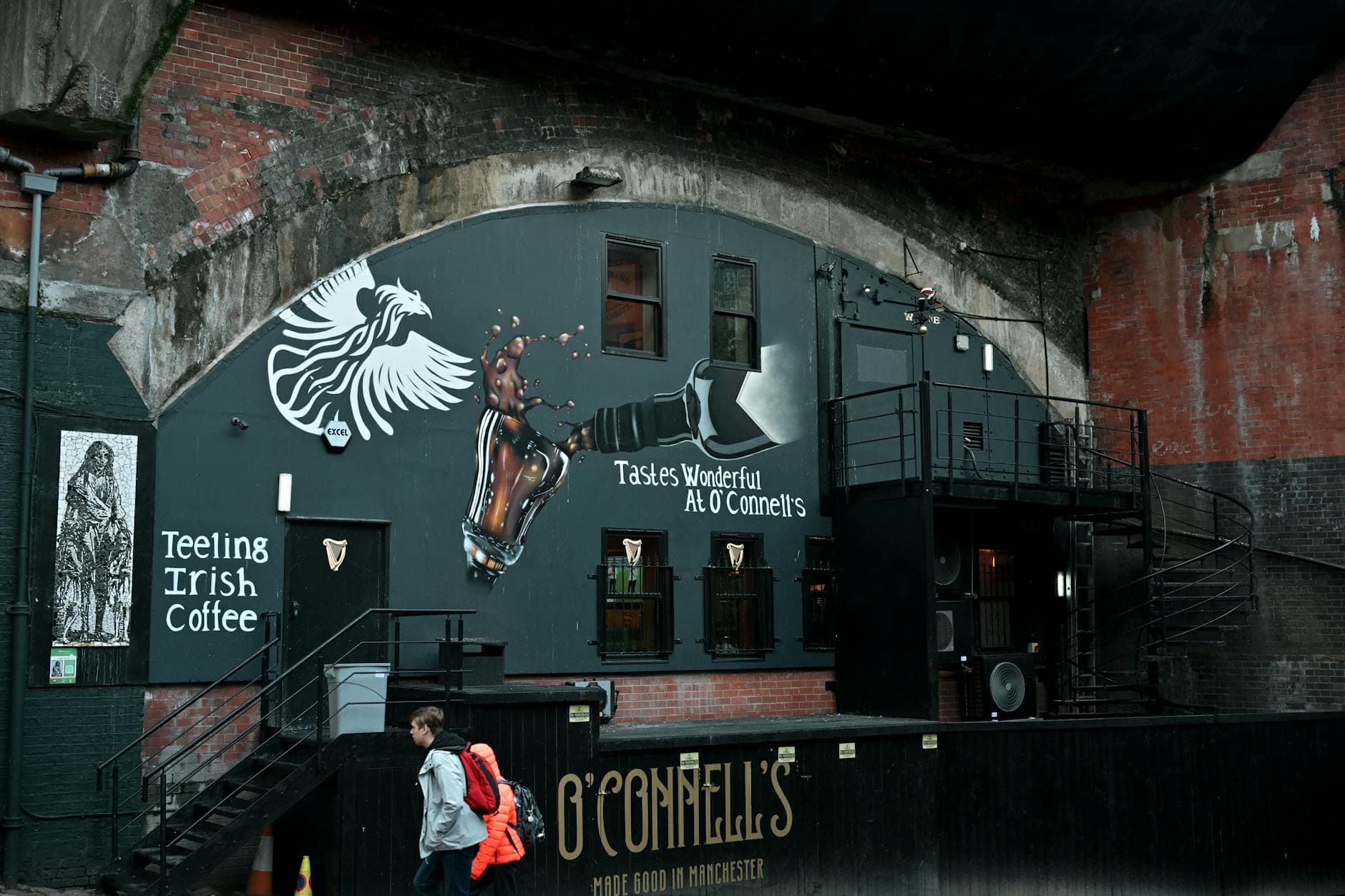 Street art mural featuring Teeling Irish Coffee in an urban alleyway.