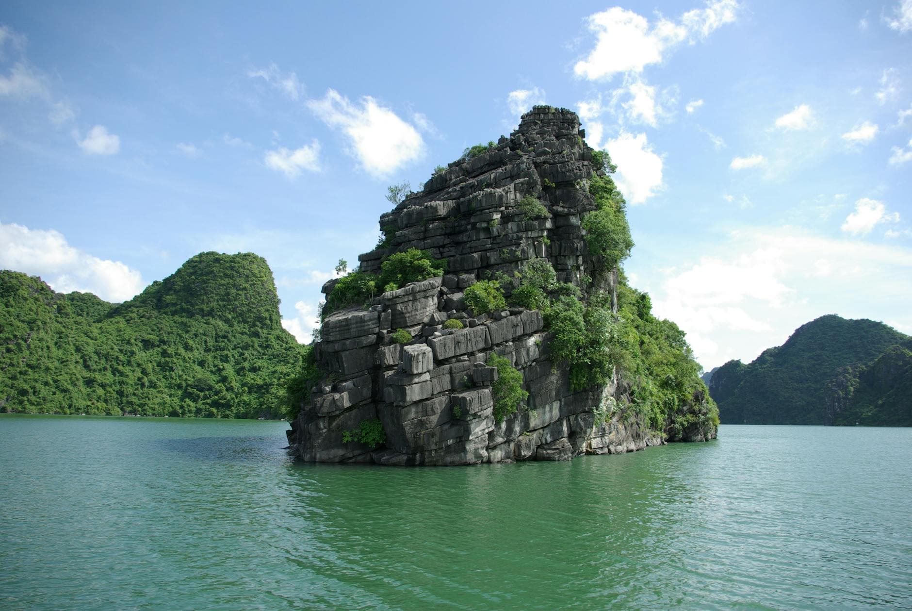 Breathtaking view of rock formations in Ha Long Bay, Vietnam, highlighting lush greenery.